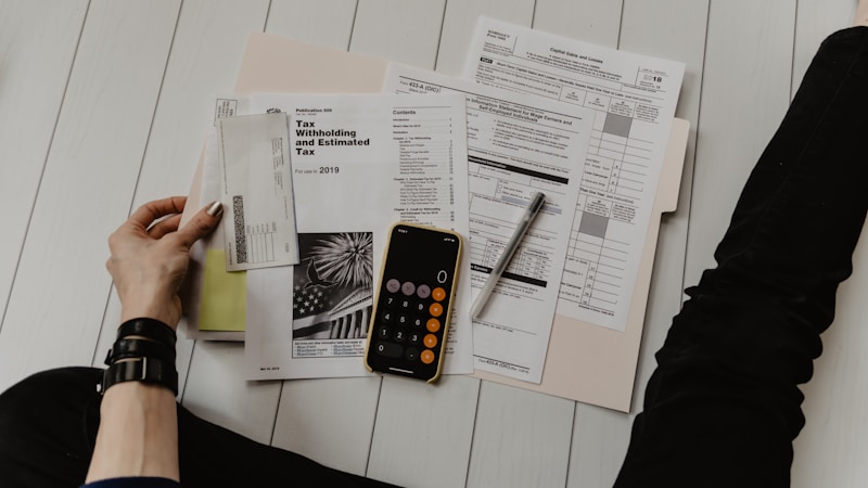 Calculator, notebook and coffee on a desk